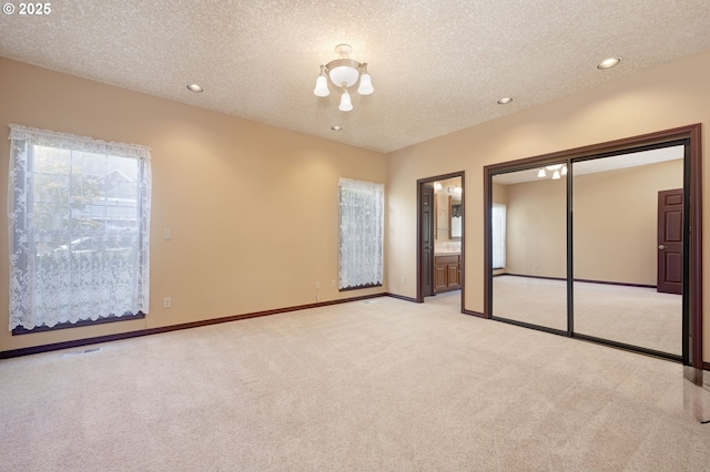16402 SE Teal Ct, Damascus, OR 97089 - unfurnished bedroom with a textured ceiling, light carpet, recessed lighting, multiple windows, and baseboards