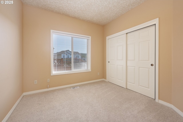 16402 SE Teal Ct, Damascus, OR 97089 - unfurnished bedroom featuring carpet flooring, a textured ceiling, a closet, and baseboards