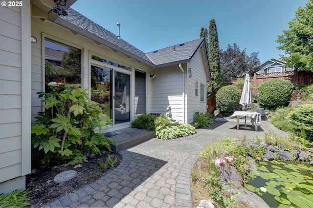 16402 SE Teal Ct, Damascus, OR 97089 - view of exterior entry with a shingled roof and a patio area