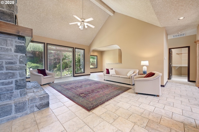 16402 SE Teal Ct, Damascus, OR 97089 - living area featuring ceiling fan, a textured ceiling, arched walkways, beam ceiling, and high vaulted ceiling