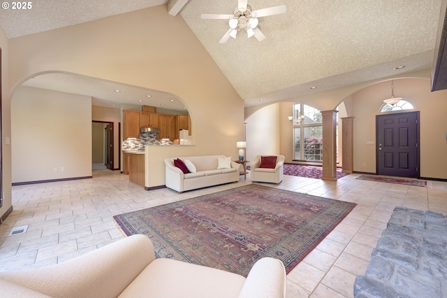 16402 SE Teal Ct, Damascus, OR 97089 - living room with arched walkways, ornate columns, high vaulted ceiling, ceiling fan, and beam ceiling