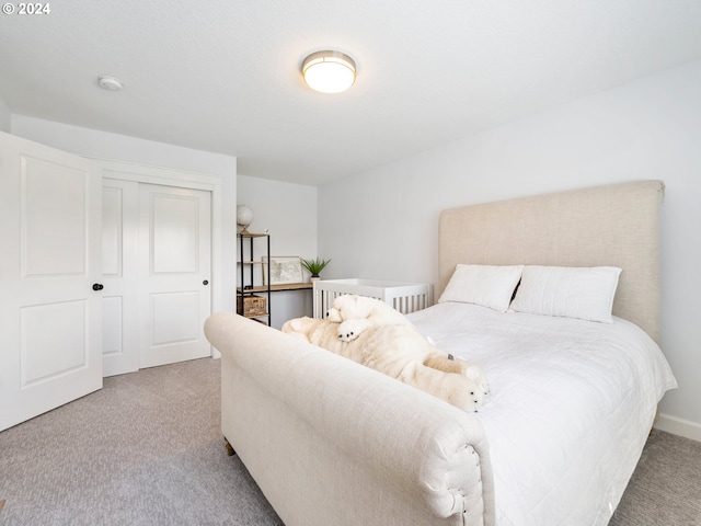 carpeted bedroom with a closet