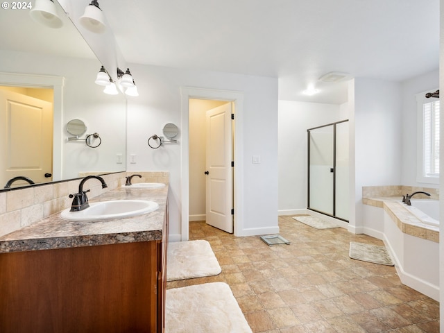 bathroom with vanity and shower with separate bathtub