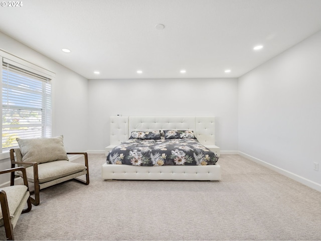 bedroom featuring light carpet