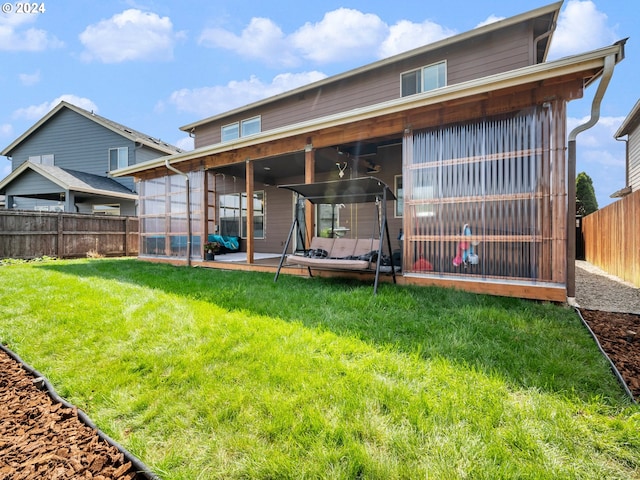 back of house with a yard and a patio