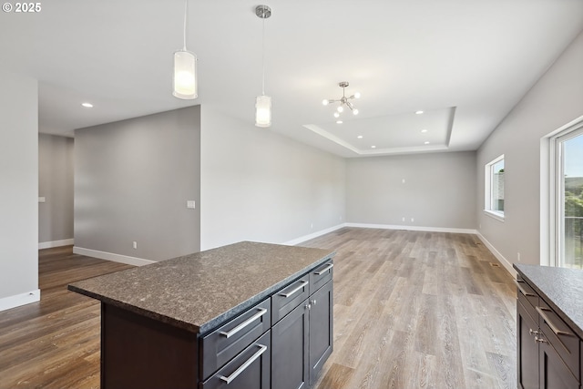 365 NW 4th St, Dufur, OR 97021 - kitchen featuring light wood-style flooring, a raised ceiling, baseboards, recessed lighting, and hanging light fixtures