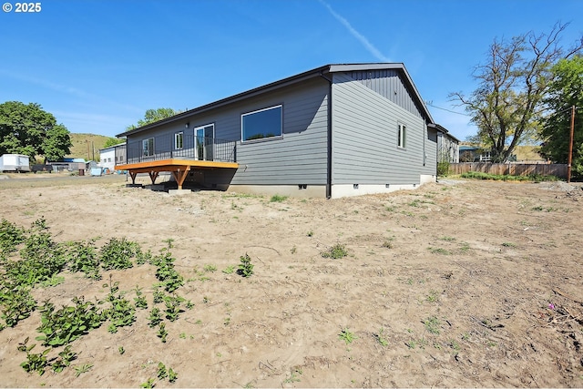 365 NW 4th St, Dufur, OR 97021 - back of property with crawl space, a wooden deck, fence, and board and batten siding