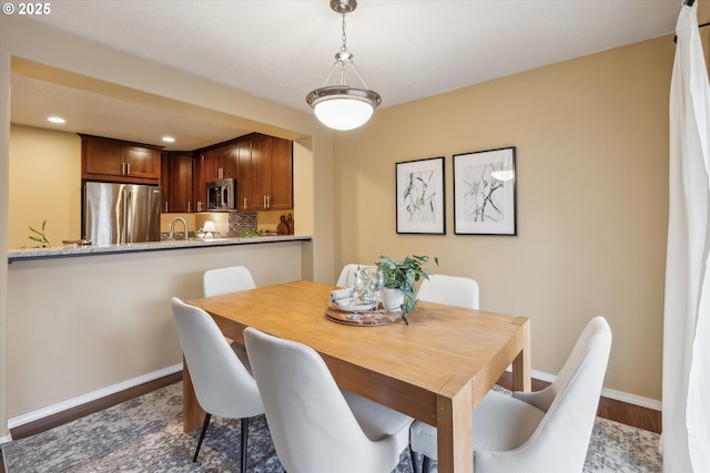 dining room with recessed lighting, wood finished floors, and baseboards