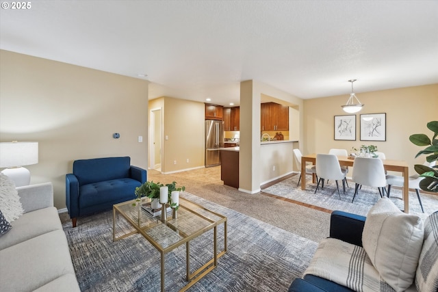 living room featuring baseboards and light carpet