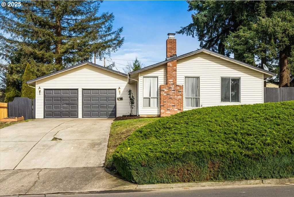 ranch-style house featuring a garage and a front yard