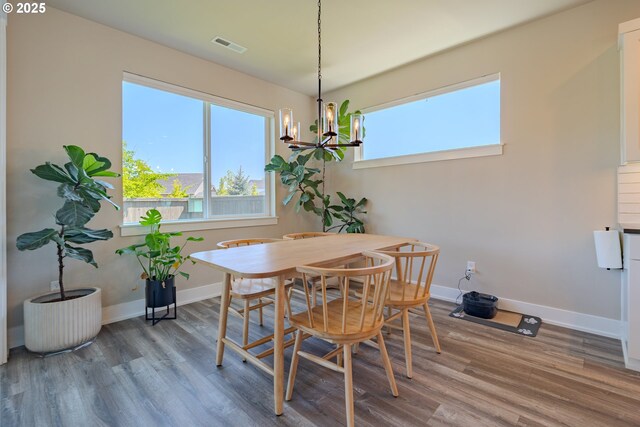 10107 NE 136th Ave, Vancouver, WA 98682 - dining space with a chandelier, wood finished floors, and baseboards