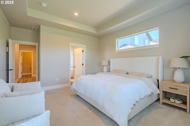 10107 NE 136th Ave, Vancouver, WA 98682 - bedroom with light colored carpet, a tray ceiling, baseboards, recessed lighting, and ensuite bathroom