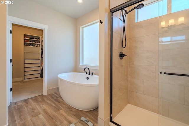 10107 NE 136th Ave, Vancouver, WA 98682 - full bathroom with wood finished floors, a walk in closet, a shower stall, a freestanding bath, and recessed lighting