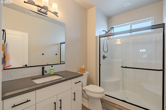 10107 NE 136th Ave, Vancouver, WA 98682 - full bathroom featuring a stall shower, tasteful backsplash, vanity, and toilet