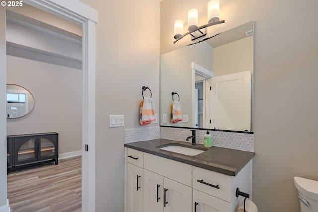 10107 NE 136th Ave, Vancouver, WA 98682 - half bath featuring tasteful backsplash, vanity, toilet, wood finished floors, and baseboards