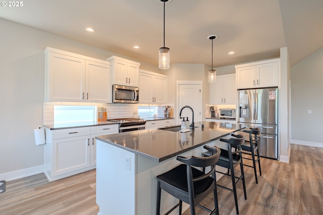 10107 NE 136th Ave, Vancouver, WA 98682 - kitchen featuring appliances with stainless steel finishes, a sink, baseboards, tasteful backsplash, and recessed lighting