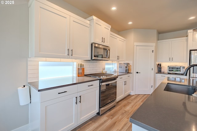 10107 NE 136th Ave, Vancouver, WA 98682 - kitchen featuring stainless steel appliances, a sink, recessed lighting, light wood finished floors, and tasteful backsplash