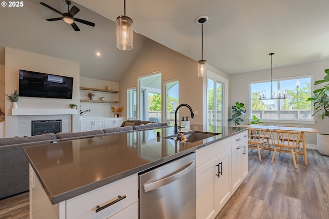 10107 NE 136th Ave, Vancouver, WA 98682 - kitchen with stainless steel dishwasher, open floor plan, a sink, light wood-type flooring, and high vaulted ceiling