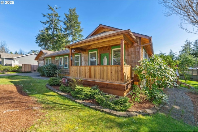view of front of house with a porch and a front yard