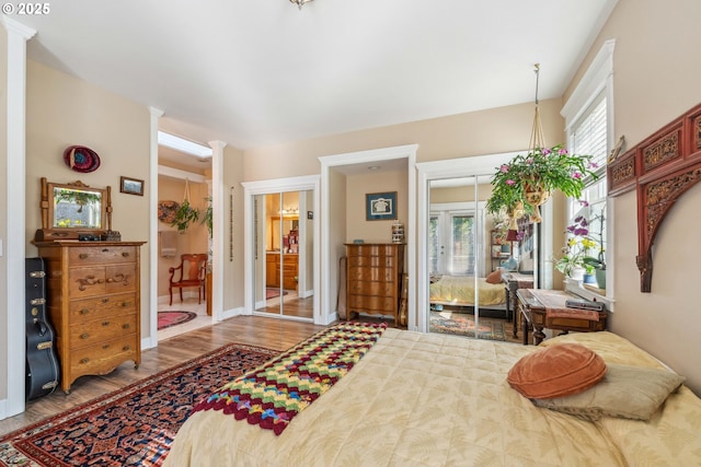 bedroom featuring wood finished floors, baseboards, and a closet