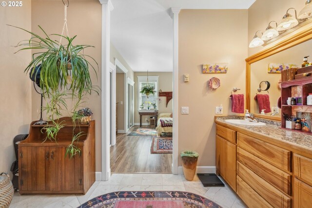 bathroom with baseboards and vanity