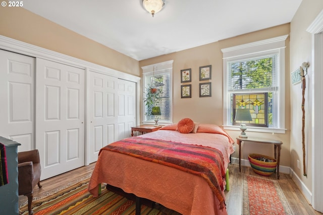 bedroom with baseboards and wood finished floors