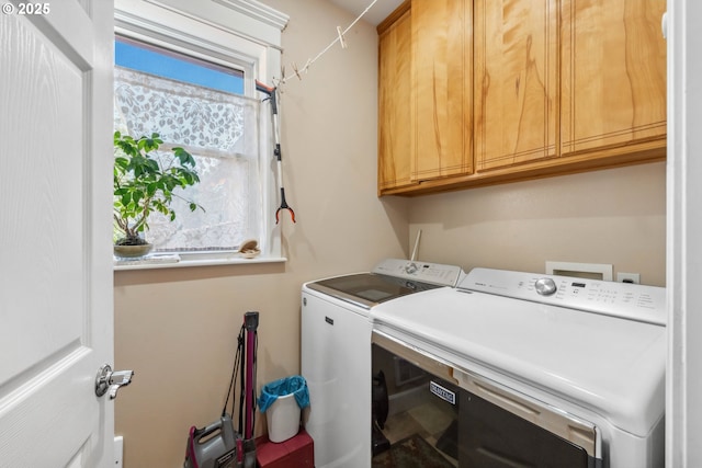 laundry area with cabinet space and washing machine and clothes dryer