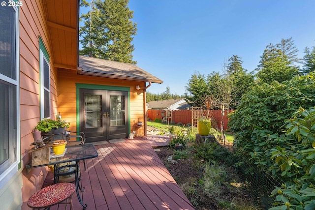 wooden deck featuring french doors and fence