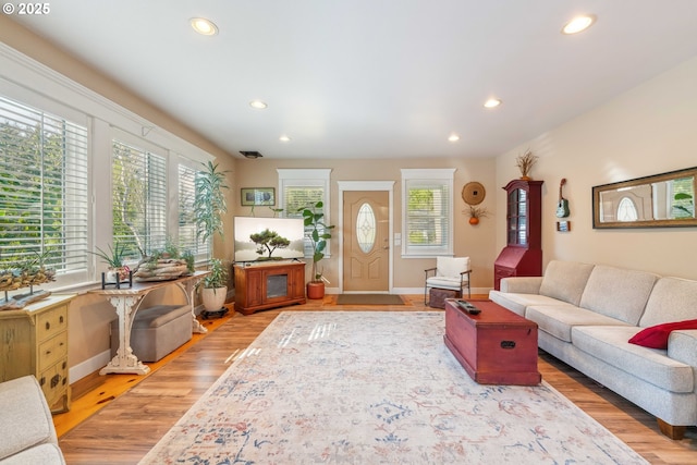living area featuring recessed lighting, plenty of natural light, and light wood finished floors