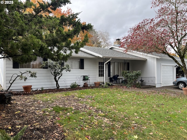 exterior space with a garage and a front lawn