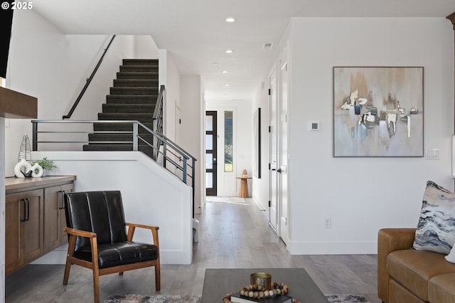 interior space with stairs, recessed lighting, baseboards, and light wood-style floors