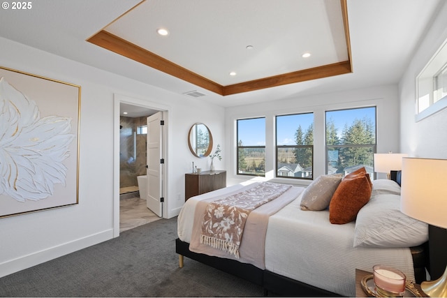 bedroom with a tray ceiling, carpet, multiple windows, and baseboards