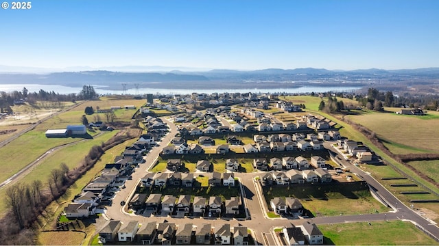 bird's eye view featuring a residential view and a water and mountain view