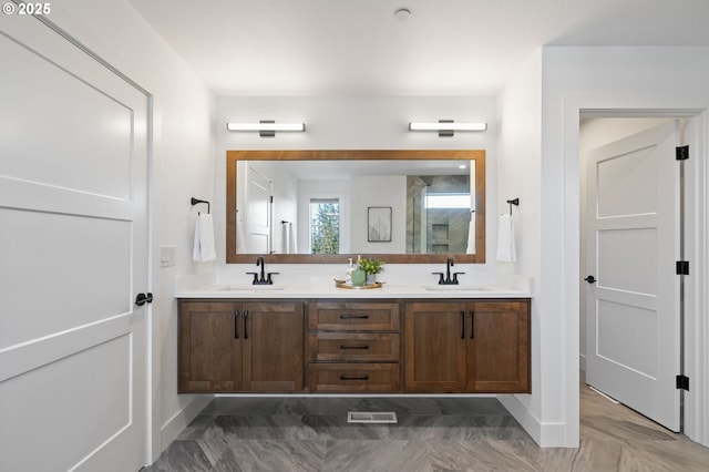 full bath with double vanity, visible vents, and a sink