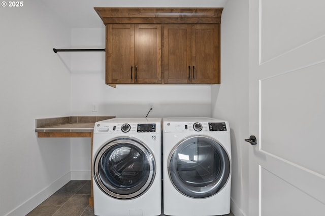 washroom with cabinet space, baseboards, and independent washer and dryer