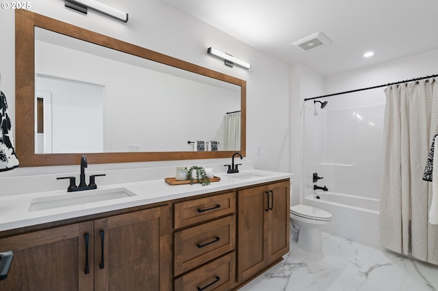 bathroom featuring toilet, marble finish floor, a sink, and visible vents