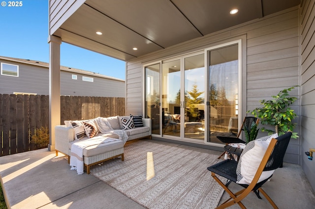 view of patio featuring fence and an outdoor living space