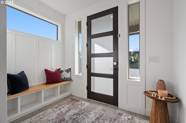 interior space with a decorative wall and wood finished floors