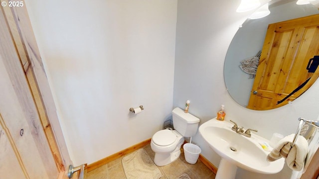 bathroom with tile patterned floors, toilet, and sink