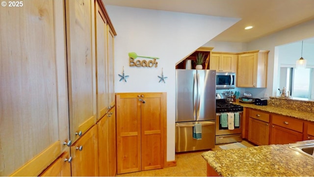 kitchen featuring light stone counters, light tile patterned flooring, hanging light fixtures, and appliances with stainless steel finishes