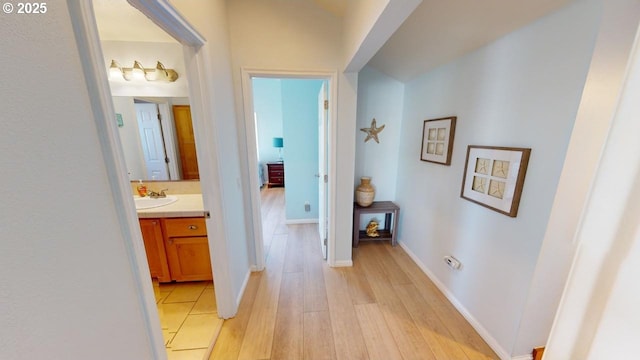 hall featuring light hardwood / wood-style floors and sink