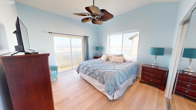 bedroom with access to exterior, light hardwood / wood-style floors, ceiling fan, and lofted ceiling