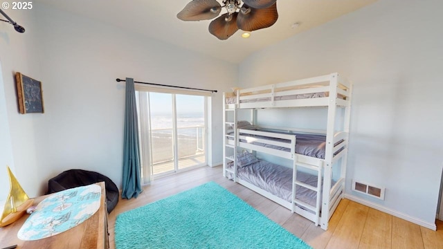 bedroom featuring ceiling fan, wood-type flooring, and vaulted ceiling