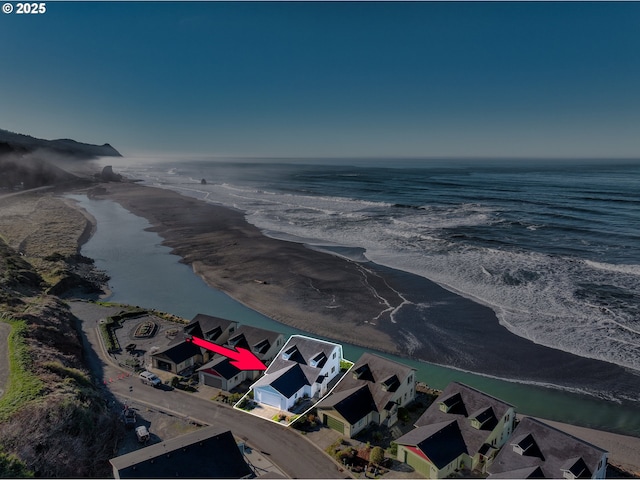 exterior space with a water view and a view of the beach