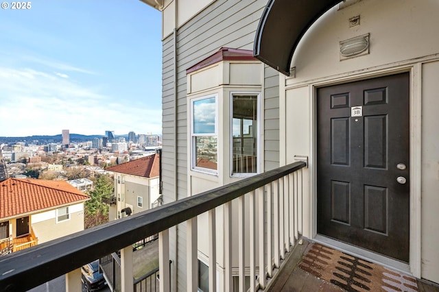 entrance to property with a balcony and a city view