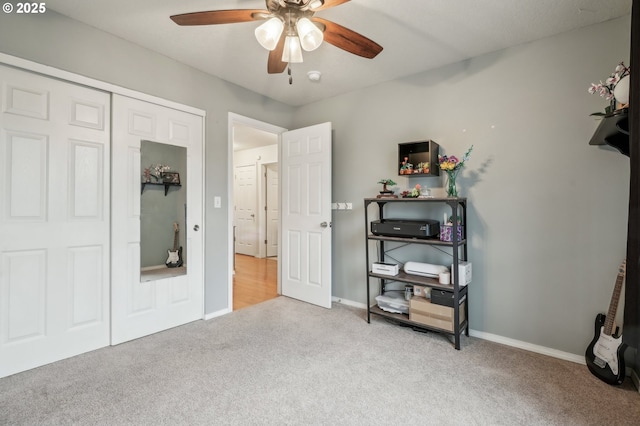 carpeted bedroom featuring ceiling fan and a closet