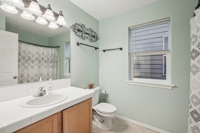 bathroom with an inviting chandelier, vanity, and toilet