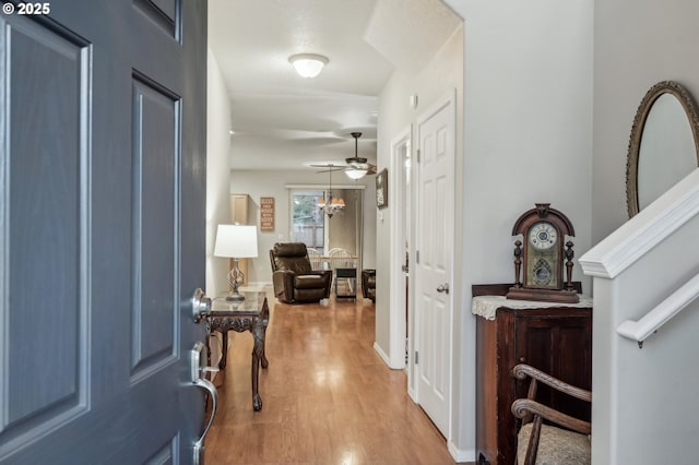 foyer with a notable chandelier and light wood-type flooring