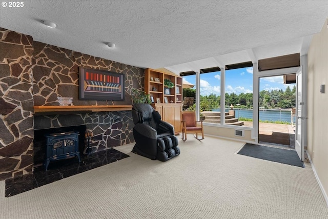 21047 NE Interlachen Ln, Fairview, OR 97024 - living area featuring a wood stove, a textured ceiling, and carpet flooring