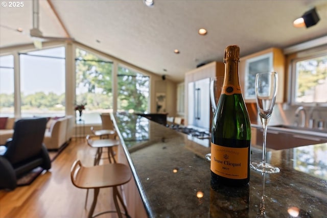 21047 NE Interlachen Ln, Fairview, OR 97024 - kitchen featuring healthy amount of natural light, recessed lighting, vaulted ceiling, wood finished floors, and a breakfast bar area